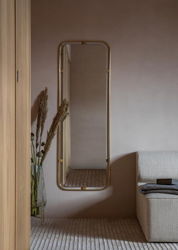 modern brass mirror on cement wall, danish mirror from menu, mirrors at designer pricing