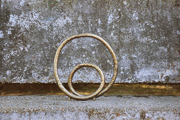 Rounded Metal Loop Sculpture In Textured Brass