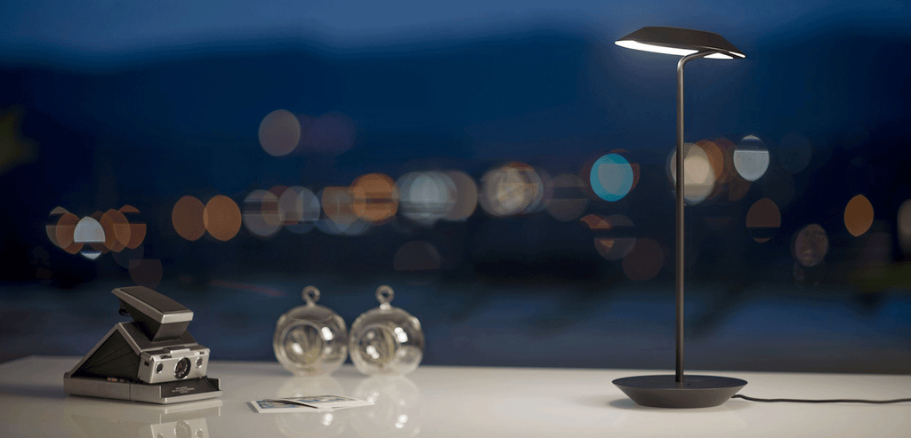 modern desk lamp lights up classic polaroid camera